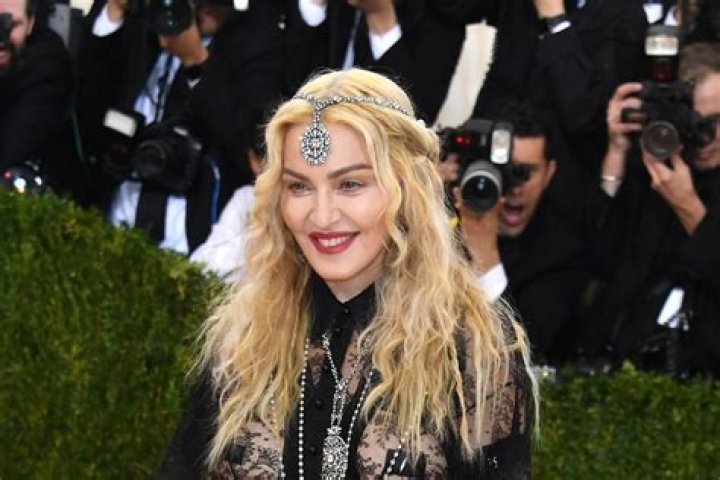 Madonna is back home after her hospitalization, has postponed her tour